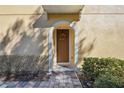 Inviting front door entrance with a wreath and a brick walkway at 2681 Sweet Magnolia Pl, Oviedo, FL 32765