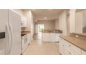 Bright kitchen with white cabinets and tan countertops at 3610 Casello Dr, New Smyrna Beach, FL 32168