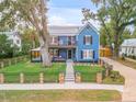 Charming two-story blue house with a well-manicured lawn at 532 Faulkner St, New Smyrna Beach, FL 32168