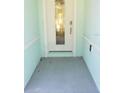 Inviting front entrance with a light-colored door and tiled flooring at 555 Coronado Cove Rd, New Smyrna Beach, FL 32168