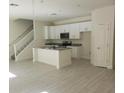 Modern kitchen with island and stainless steel appliances at 555 Coronado Cove Rd, New Smyrna Beach, FL 32168