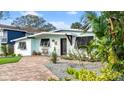 Mid-century home with updated landscaping and brick paver driveway at 624 S Pine St, New Smyrna Beach, FL 32169