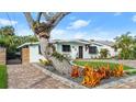 Cute mid-century home with unique landscaping and a brick driveway at 624 S Pine St, New Smyrna Beach, FL 32169