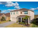 Two-story house with a beige exterior, brown roof, and a screened patio at 639 Lazio Cir, Debary, FL 32713