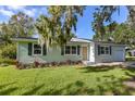 Newly renovated light green house with landscaping at 710 Corbin Park Rd, New Smyrna Beach, FL 32168