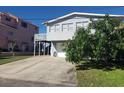 House exterior showcasing a two-story home with a deck and driveway at 824 Garfish Ave, New Smyrna Beach, FL 32169