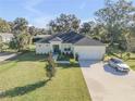 Aerial view of a single-story house with a large lawn and a driveway at 1929 Pioneer Trl, New Smyrna Beach, FL 32168