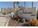The Pelican Select Rentals entrance with lush landscaping and condo in the background at 2401 S Atlantic Ave # C206, New Smyrna Beach, FL 32169