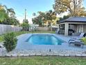 Relaxing pool area with pebble tec decking and spacious backyard at 2729 Pine Tree Dr, Edgewater, FL 32141