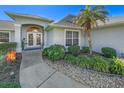 Well-maintained home exterior with a landscaped walkway and entry at 37 Loggerhead Ct, Ponce Inlet, FL 32127