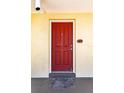 Red front door to condo unit with a welcome mat at 3801 S Atlantic Ave # Ut104, New Smyrna Beach, FL 32169