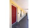 Hallway with red condo door and additional unit doors visible at 3801 S Atlantic Ave # Ut104, New Smyrna Beach, FL 32169