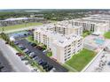 Aerial view of condos, parking, and tennis courts near the beach at 4175 S Atlantic Ave # 2150, New Smyrna Beach, FL 32169