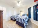 Bedroom with two twin beds, tile floor, and ceiling fan at 5300 S Atlantic Ave # 1-203, New Smyrna Beach, FL 32169