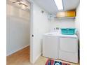Laundry room with washer, dryer, and storage shelves at 5300 S Atlantic Ave # 1-203, New Smyrna Beach, FL 32169