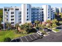 Condo building with palm trees and parking in front, ocean view at 5300 S Atlantic Ave # 17-506, New Smyrna Beach, FL 32169