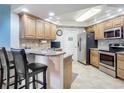Modern kitchen with granite countertops, stainless steel appliances, and wood cabinets at 5300 S Atlantic Ave # 17-506, New Smyrna Beach, FL 32169