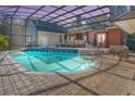Inviting kidney-shaped pool with a covered patio and lounge chairs at 535 Valley Stream Dr, Geneva, FL 32732