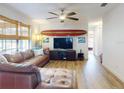 Relaxing living room featuring a sectional sofa, hardwood floors, and a large TV at 622 Yupon Ave, New Smyrna Beach, FL 32169