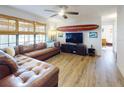 Relaxing living room featuring a sectional sofa, hardwood floors, and a large TV at 622 Yupon Ave, New Smyrna Beach, FL 32169