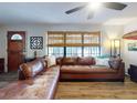 Spacious living room with sectional sofa, hardwood floors and large windows at 622 Yupon Ave, New Smyrna Beach, FL 32169