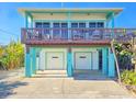 Two-story beach house with two-car garage and balcony at 6244 S Atlantic Ave, New Smyrna Beach, FL 32169