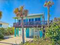 Beach house with two-car garage and large deck at 6244 S Atlantic Ave, New Smyrna Beach, FL 32169