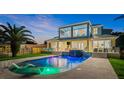 Inviting pool and spa area with outdoor seating and lighting at 73 Cunningham Dr, New Smyrna Beach, FL 32168