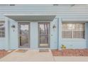 Two-unit building entrance with gray doors and welcome mats at 101 N Pine St # 7, New Smyrna Beach, FL 32169