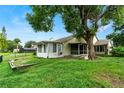 Backyard with a screened porch and grassy area at 141 Green Heron Ct, Daytona Beach, FL 32119