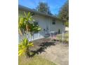 Small patio with table and chairs near the back door at 2017 Royal Palm Dr, Edgewater, FL 32141