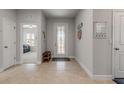 Bright entryway with tile flooring, bench, and view of a living area at 270 Eagle Harbor Way, Daytona Beach, FL 32124