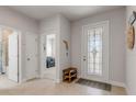 Neutral-toned entryway with tile floor, stained glass door and a sitting bench at 270 Eagle Harbor Way, Daytona Beach, FL 32124