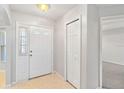 Bright entryway with coat closet and tiled floor at 3313 Celena Cir, St Cloud, FL 34769