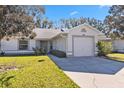 Front view of a house with a garage and landscaping at 3313 Celena Cir, St Cloud, FL 34769