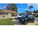 Two SUVs parked in the driveway of a tan house at 40 Sandra Cir, New Smyrna Beach, FL 32168