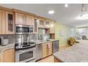 Modern kitchen with stainless steel appliances and light wood cabinets at 4151 S Atlantic Ave # 112, New Smyrna Beach, FL 32169