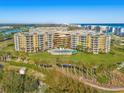 Aerial view of building showcasing ocean views and resort-style amenities at 4670 Links Village Dr # C402, Ponce Inlet, FL 32127