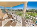 Spacious balcony overlooking the golf course and tropical landscape at 4670 Links Village Dr # C402, Ponce Inlet, FL 32127