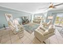 Bright living room with comfortable seating and a large-screen TV at 4670 Links Village Dr # C402, Ponce Inlet, FL 32127