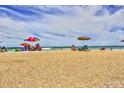 Relaxing beach scene with colorful umbrellas at 5300 S Atlantic Ave # 13307, New Smyrna Beach, FL 32169