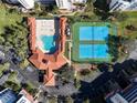 Aerial view showing resort amenities including pool, tennis courts, and parking at 5300 S Atlantic Ave # 9-304, New Smyrna Beach, FL 32169