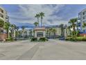 Gated entry to Oceanwalk Condominiums with sales office and tropical landscaping at 5300 S Atlantic Ave # 9-304, New Smyrna Beach, FL 32169