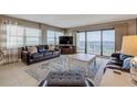 Living room with leather furniture, ocean views, and balcony access at 5499 S Atlantic Ave # 905, New Smyrna Beach, FL 32169