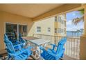 Ocean view balcony with table and chairs at 701 N Atlantic Ave # 203, New Smyrna Beach, FL 32169