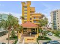 Attractive yellow building with ocean views and gated entrance at 701 N Atlantic Ave # 203, New Smyrna Beach, FL 32169
