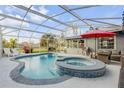 Inviting kidney-shaped pool with a spa and covered patio at 1052 Tompkins Dr, Port Orange, FL 32129