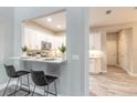 Modern kitchen with white cabinets, stainless steel appliances, and a breakfast bar at 3414 Medici Blvd, New Smyrna Beach, FL 32168