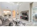 Open-concept living room with high ceilings, modern decor, and a view of the kitchen at 3414 Medici Blvd, New Smyrna Beach, FL 32168