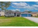 Attractive curb appeal with a neat lawn, landscaping, and a welcoming entrance at 3769 Fiano Dr, Port Orange, FL 32129
